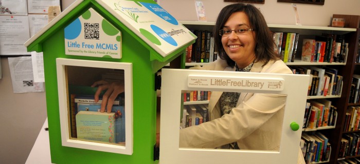 Melissa Baker, Marketing and Program Coordinator for the Montgomery County Memorial Library System, loads up the new Little Free Library at the CentralLibrary in Conroe.