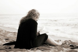 Woman reading a book on the beach