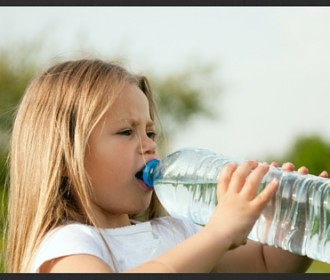 girl drinking a bottle of water