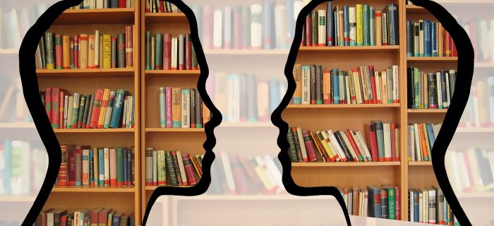 Silhouettes with books behind them