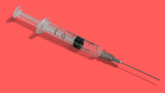 hypodermic needle on red background