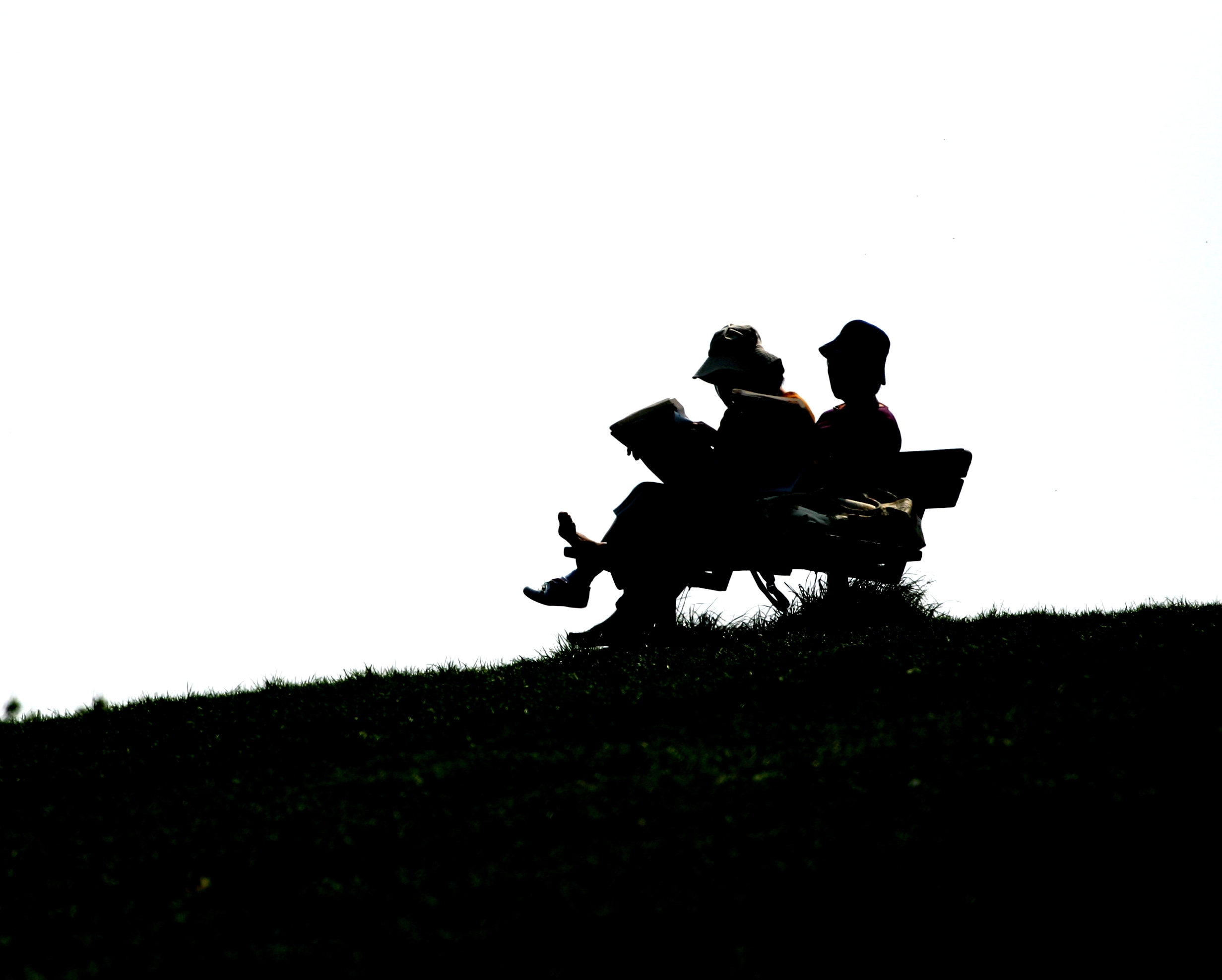 two people on a bench reading
