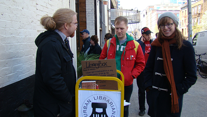 volunteer librarians on street in urban setting