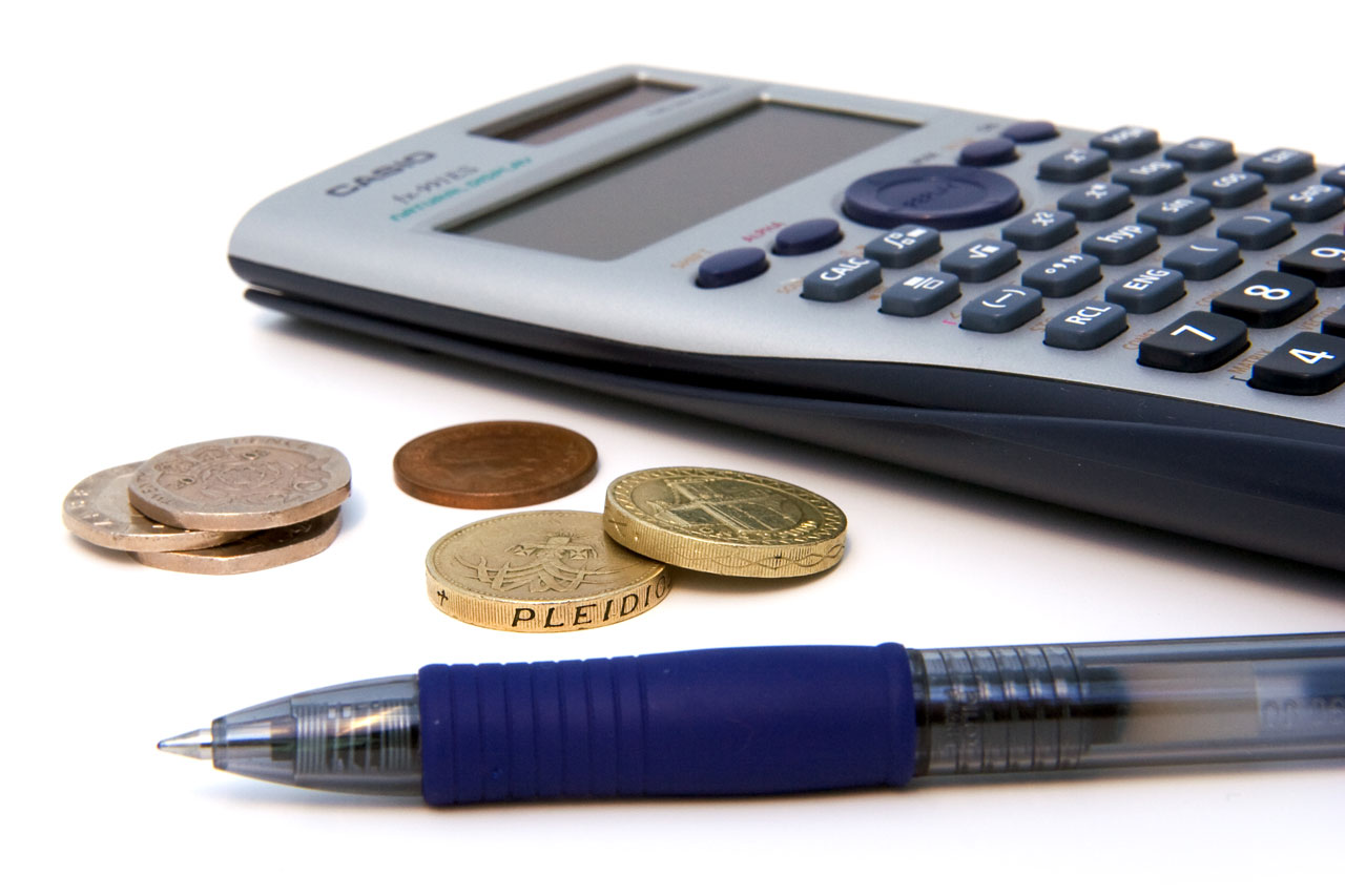 calculator, coins, and a pen