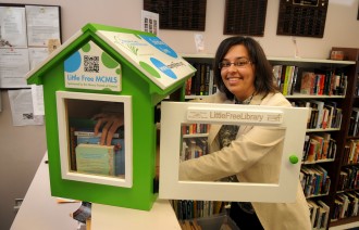 Melissa Baker, Marketing and Program Coordinator for the Montgomery County Memorial Library System, loads up the new Little Free Library at the CentralLibrary in Conroe.