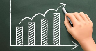 hand drawing a graph on chalkboard