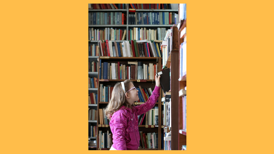 girl perusing library stacks