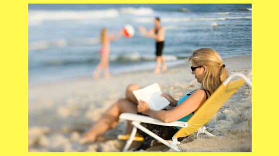 Woman in beach chair reading
