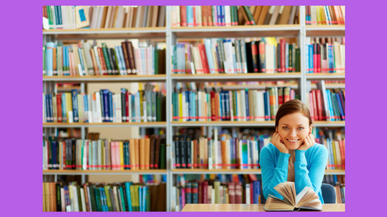 woman with book in front of book shelves
