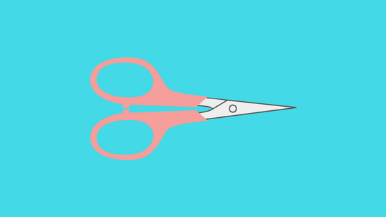 scissors with pink handle on blue background