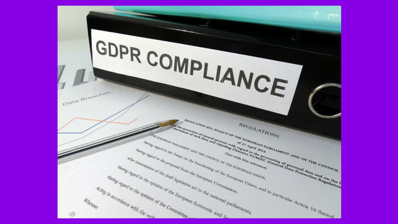 Binder label that says GDPR Compliance on top of papers that say regulations