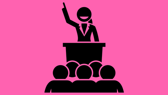 illustration of a woman at a podium speaking to a group