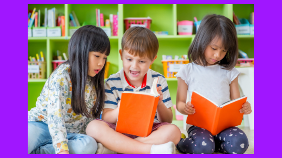 children looking at a book