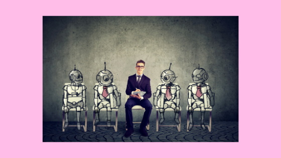 photo of a person sitting in a chair surrounded by robots