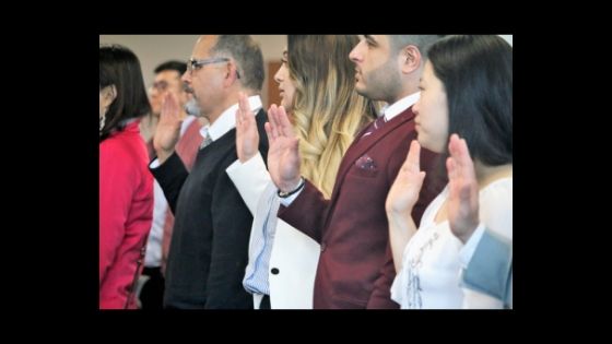 Group of people taking citizenship oath