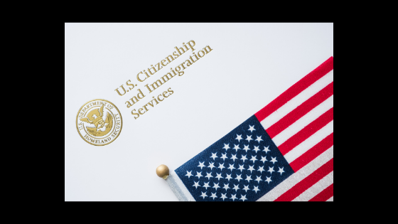 image of an american flag with the words U.S. citizenship and immigration services above it in gold