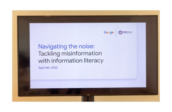 Video monitor showing title of program “Navigating the Noise: Tackling Misinformation with Information Literacy.”